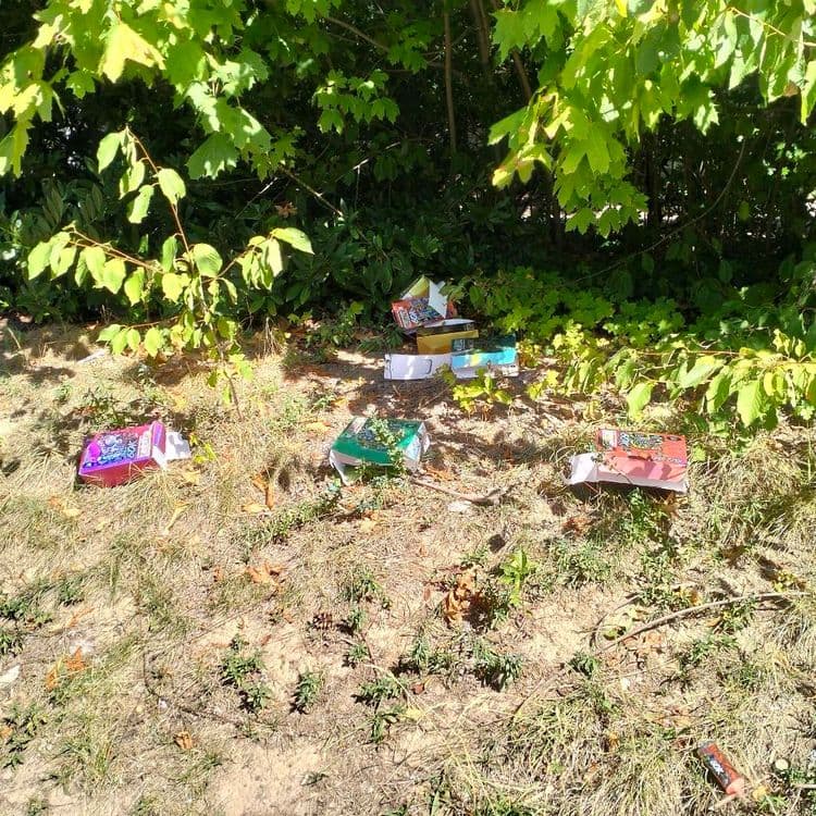 Matelas, pneu usagé et emballages divers abandonnés sur un parking public